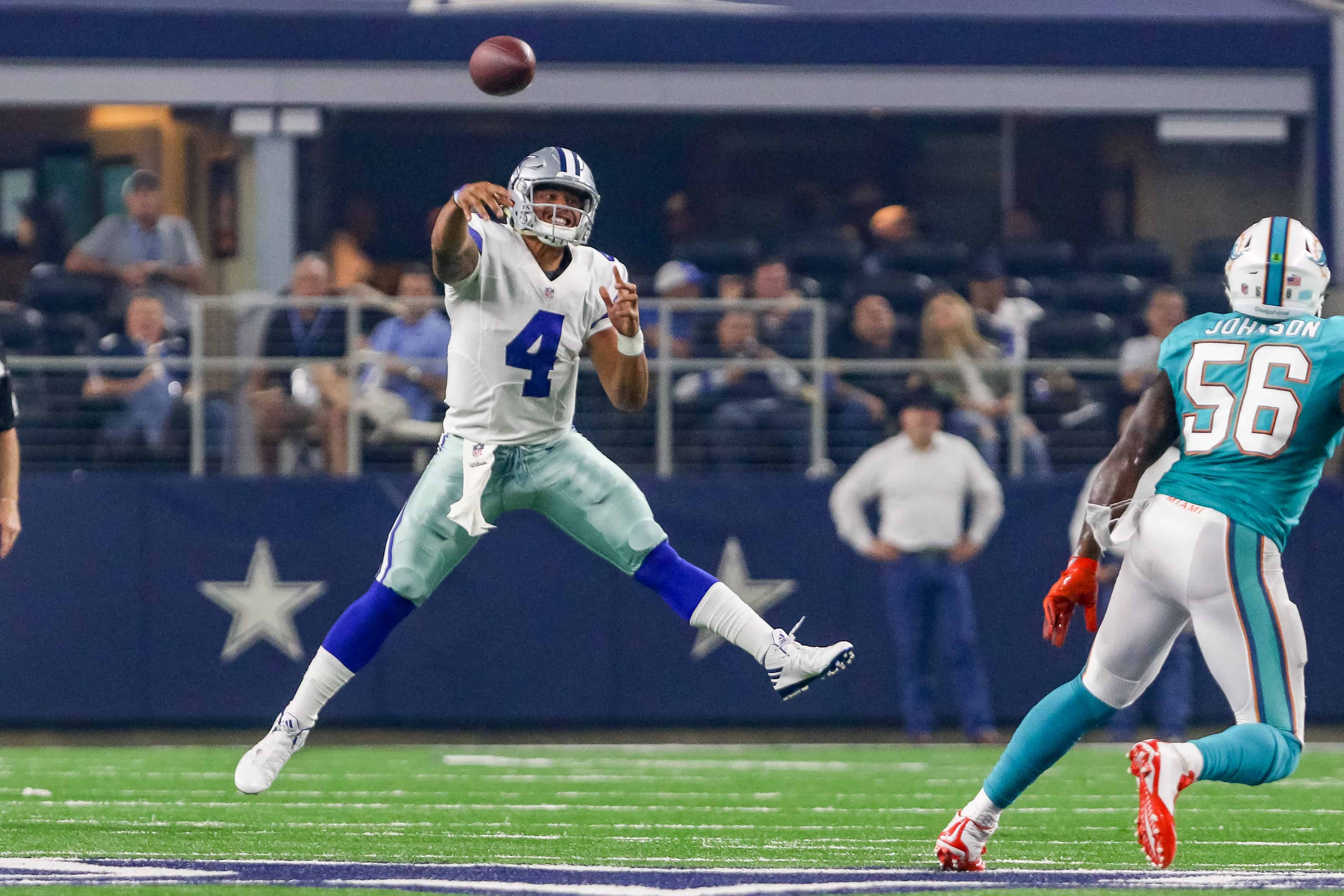Dak Prescott throws pass on the run against Dolhins