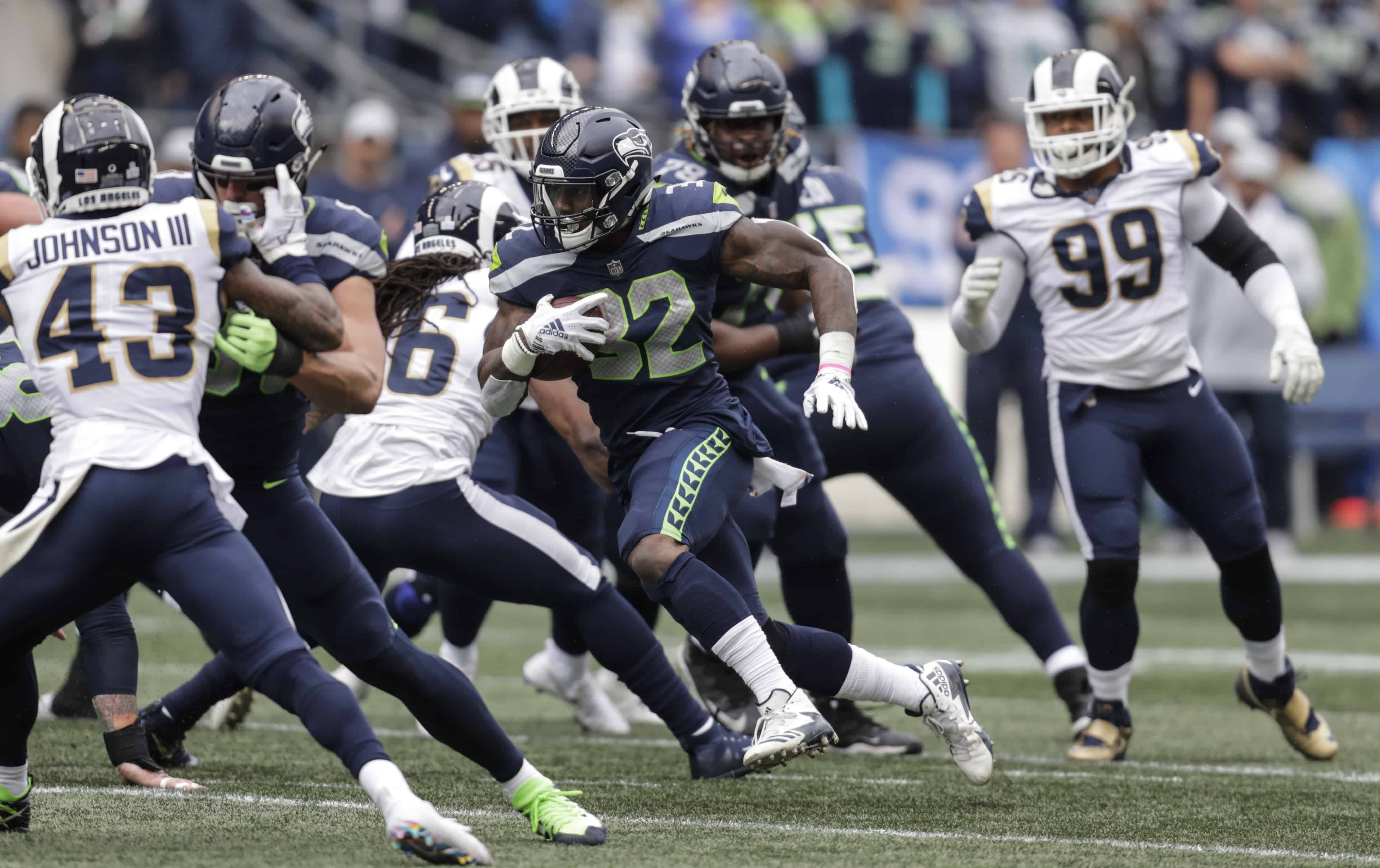 Chris Carson breaks tackles against the Rams