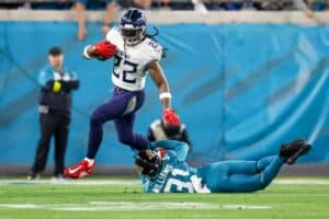 Derrick Henry #22 of the Tennessee Titans breaks the tackle of Darious Williams #31 of the Jacksonville Jaguars