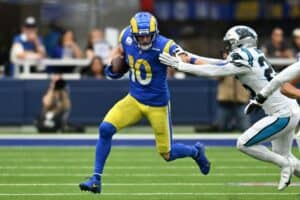 Cooper Kupp stiff arms defender.