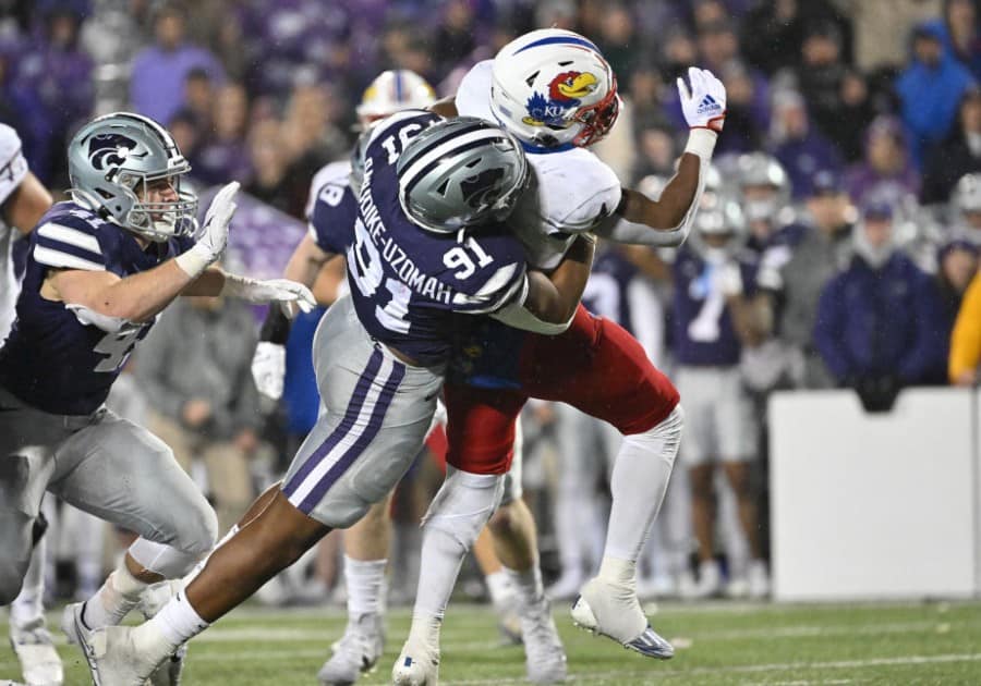 Felix Anudike-Uzomah tackles Devin Neal