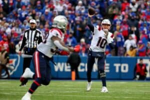 Mac Jones throws a pass against the Bills