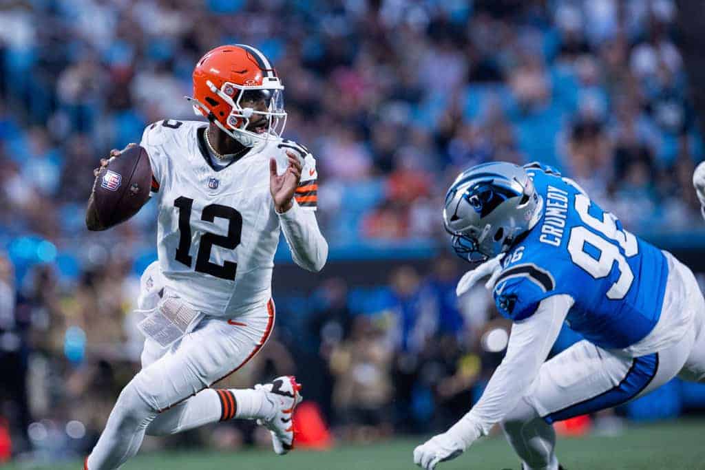 Shedeur Sanders rolls out of the pocket in an NFL preseason game