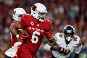 Arizona Cardinals football player running with the ball during an NFL game.
