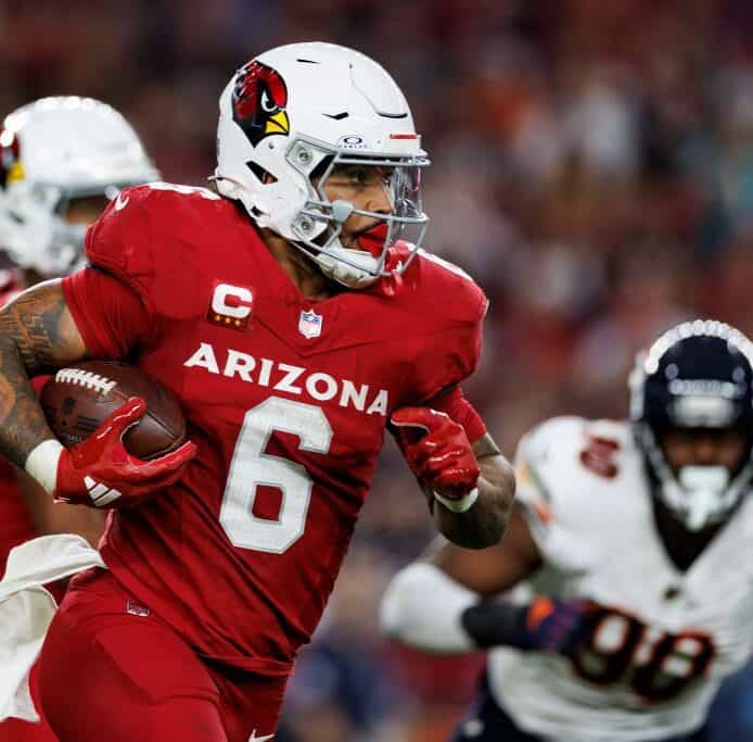 Arizona Cardinals football player running with the ball during an NFL game.