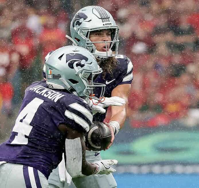 Kansas State quarterback Avery Johnson hands off the ball to his running back