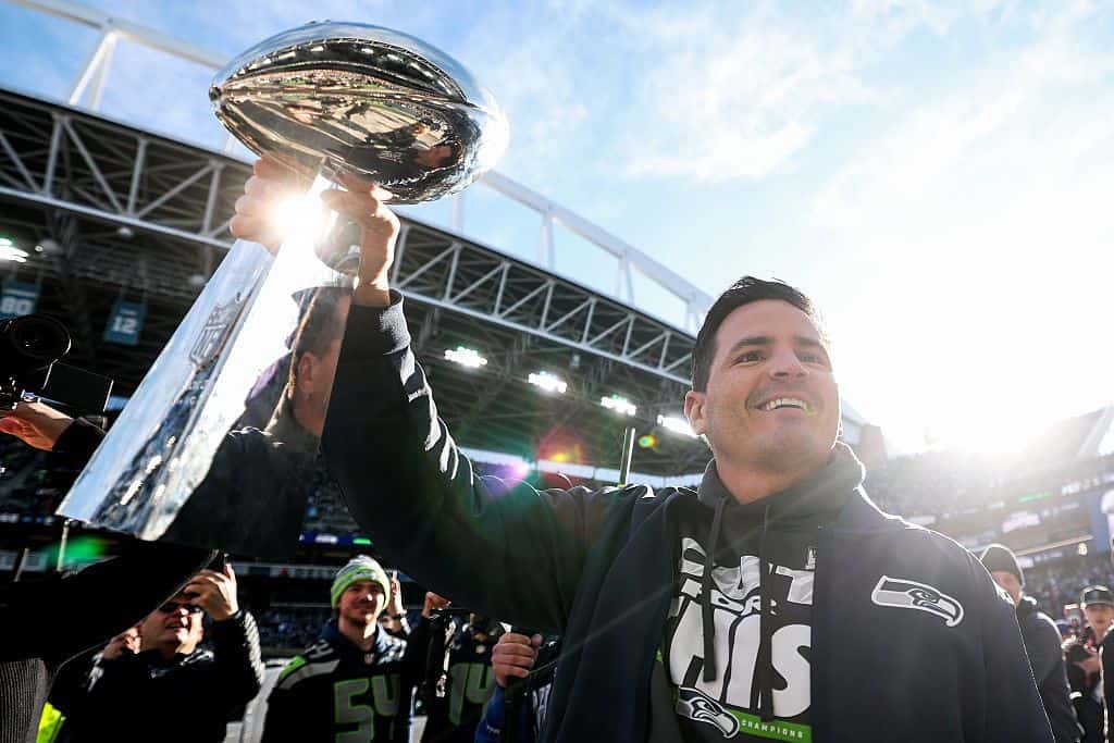 Seattle Seahawks coach Mike Macdonald holds the Lombardi trophy during the celebration parade